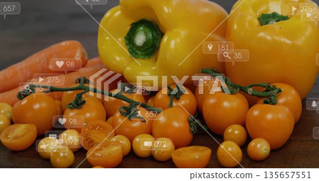 Displaying bell peppers, carrots, cherry tomato vine on dark wooden tabletop with digital icons Displaying bell peppers, carrots, cherry tomato vine on dark wooden tabletop with digital icons 135657551