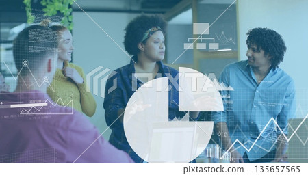 Brainstorming group of five colleagues collaborating around laptop at office space, charts overlay 135657565