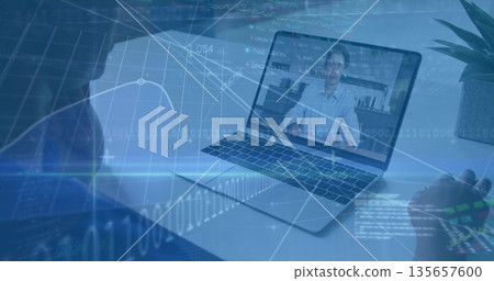 Showing laptop screen with man discussing financial overlays at home desk, with headset, plant 135657600