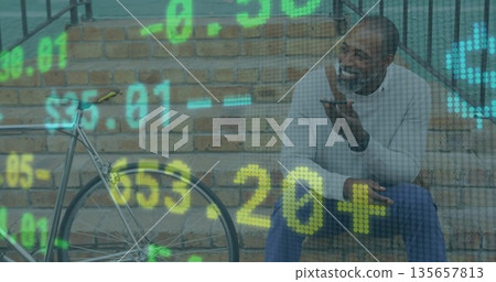 Sitting man speaking into smartphone on outdoor brick steps by bicycle with financial data overlay Sitting man speaking into smartphone on outdoor brick steps by bicycle with financial data overlay 135657813