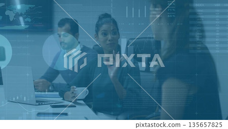 Gesturing female wearing blouse holding coffee mug and discussing data charts at conference table 135657825