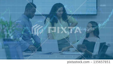 Collaborating team in suits analyzing financial charts at conference table, with laptop, tablet Collaborating team in suits analyzing financial charts at conference table, with laptop, tablet 135657851