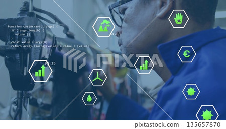 Inspecting hoses, technician wearing work jacket and glasses in factory, with code and data icons 135657870