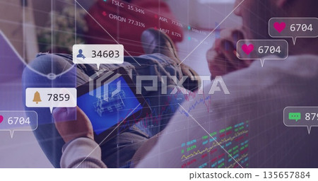 Professional analyzing 3D model on tablet in office, with floating notifications and stock charts 135657884