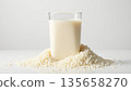 Fresh Milk Glass Surrounded by Soft White Grains on Plain Background 135658270