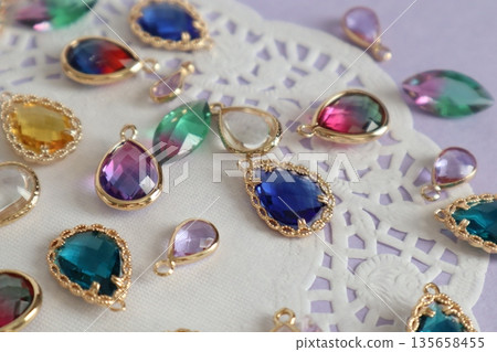 Colorful blue glass beads and lace paper Colorful blue glass beads and lace paper 135658455
