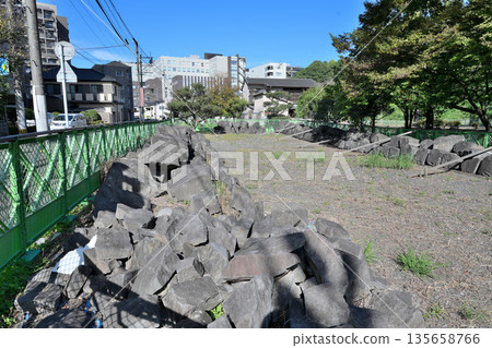 Higo Kumamoto Castle and the collapsed stone walls being preserved Higo Kumamoto Castle and the collapsed stone walls being preserved 135658766