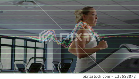 Running woman wearing sports bra on treadmill in gym, console display and graph overlay, copy space 135658878