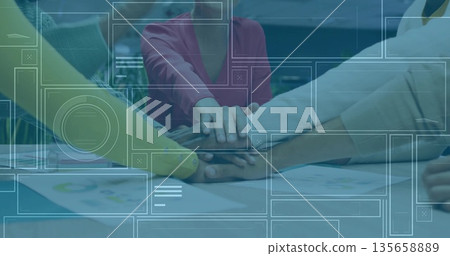 Uniting five professionals joining hands on wooden conference table with charts, digital overlay Uniting five professionals joining hands on wooden conference table with charts, digital overlay 135658889