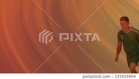 Jogging athlete wearing green sports uniform and shoes in studio with orange backdrop, copy space Jogging athlete wearing green sports uniform and shoes in studio with orange backdrop, copy space 135658904
