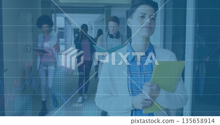 Leading educator walking in school hallway, with yellow folder and translucent line graph overlay Leading educator walking in school hallway, with yellow folder and translucent line graph overlay 135658914