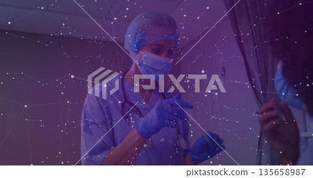 Gesturing masked nurse in scrubs conducting consultation in area 3, with stethoscope and curtain Gesturing masked nurse in scrubs conducting consultation in area 3, with stethoscope and curtain 135658987