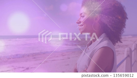 Gazing woman leaning against railing on beachside walkway, with beach and lens flare, copy space Gazing woman leaning against railing on beachside walkway, with beach and lens flare, copy space 135659012