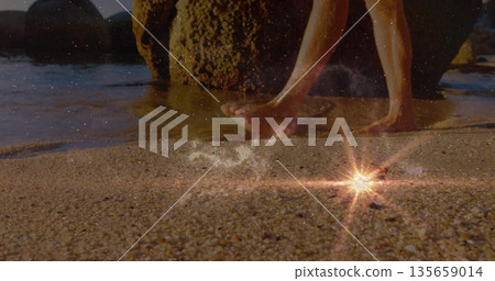 Stepping bare feet on wet pebbly shoreline by mossy rocks with starburst reflection, copy space Stepping bare feet on wet pebbly shoreline by mossy rocks with starburst reflection, copy space 135659014