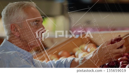 blue-shirted man selecting red apples in grocery store, with wooden bin and wristwatch, copy space 135659019