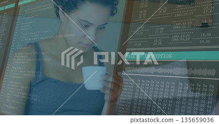Studying software developer holding white coffee mug and debugging encryption code on desk monitor Studying software developer holding white coffee mug and debugging encryption code on desk monitor 135659036