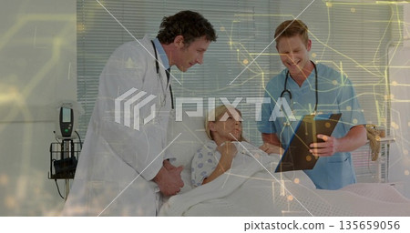 Physician examining patient condition in hospital room, with nurse pointing clipboard Physician examining patient condition in hospital room, with nurse pointing clipboard 135659056