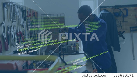 Technician in blue hoodie operating drill press in workshop with pegboard, code overlay, copy space Technician in blue hoodie operating drill press in workshop with pegboard, code overlay, copy space 135659171