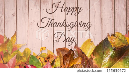 Image of happy thanksgiving day text over autumn leaves wooden background 135659672