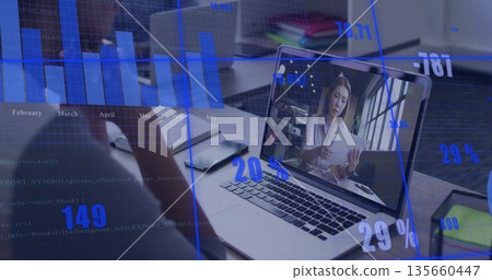 Showing man joining online meeting at office desk, listening with paperwork and analytics overlay 135660447