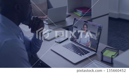 Resting chin on hand, man wearing business casual, watching laptop screen at office, copy space 135660452