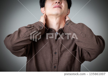 Middle-aged woman suffering from neck pain Middle-aged woman suffering from neck pain 135661007