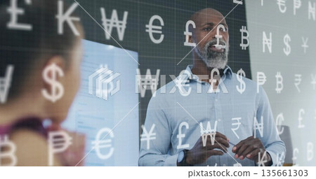 Gesturing presenter in blue shirt pointing at display screen in meeting room, with currency symbols Gesturing presenter in blue shirt pointing at display screen in meeting room, with currency symbols 135661303