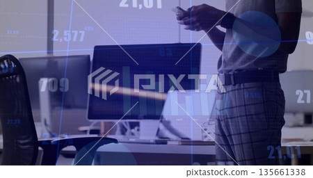 Analyzing man wearing polo shirt using smartphone and monitor for charts in office, copy space Analyzing man wearing polo shirt using smartphone and monitor for charts in office, copy space 135661338
