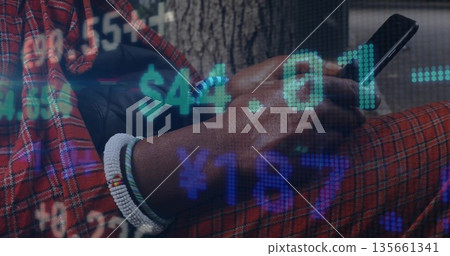 Man in red plaid and beaded bracelets tapping smartphone on park bench, with financial graphics Man in red plaid and beaded bracelets tapping smartphone on park bench, with financial graphics 135661341