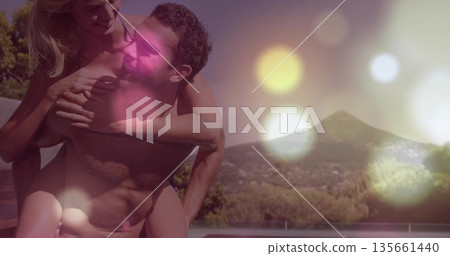 Giving piggyback ride man in swim trunks carrying bikini-clad woman on pool deck, with bokeh lights Giving piggyback ride man in swim trunks carrying bikini-clad woman on pool deck, with bokeh lights 135661440