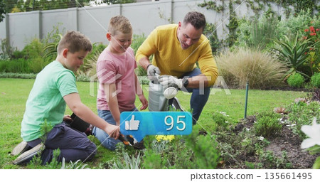 Tending man in yellow sweater and boys kneeling on backyard lawn, with watering can, trowel, gloves Tending man in yellow sweater and boys kneeling on backyard lawn, with watering can, trowel, gloves 135661495