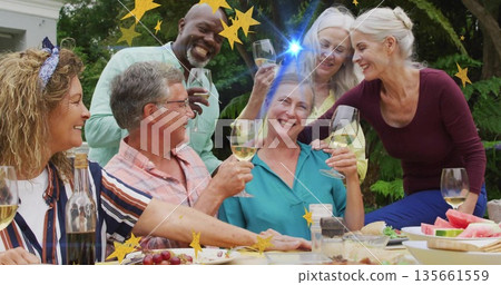 Six friends raising wine glasses on backyard patio, with wine bottle, grapes and star overlays Six friends raising wine glasses on backyard patio, with wine bottle, grapes and star overlays 135661559