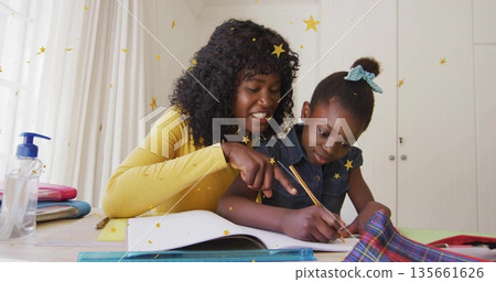 Leaning mother guiding daughter writing homework at home study area, with notebook pencil sanitizer Leaning mother guiding daughter writing homework at home study area, with notebook pencil sanitizer 135661626