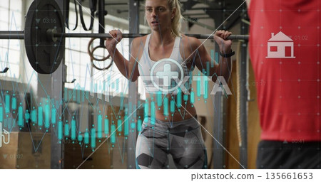 Squatting woman in sportswear barbell squat in gym, with squat rack rings and digital overlays Squatting woman in sportswear barbell squat in gym, with squat rack rings and digital overlays 135661653