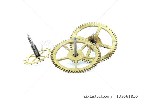 Close-up view of antique brass clock gears and shafts on a white background Close-up view of antique brass clock gears and shafts on a white background 135661810