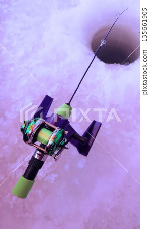 Close-up of ice fishing tackle and hole for smelt fishing 135661905