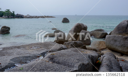 Granite Rocks on the Shoreline with Marine Plastic Pollution Awareness Granite Rocks on the Shoreline with Marine Plastic Pollution Awareness 135662518