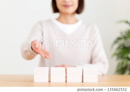 White plain block and middle-aged woman White plain block and middle-aged woman 135662552