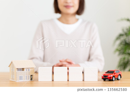 White plain block, house, car and middle-aged woman 135662580