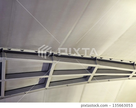 Abstract view of a white tensile fabric structure and metal framing. 135663053