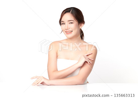 A beautiful young Asian woman with clean, fresh skin against a white background. Skincare, facial treatment, cosmetology, beauty, and spa. An elegant portrait of an Asian woman. A beautiful young Asian woman with clean, fresh skin against a white background. Skincare, facial treatment, cosmetology, beauty, and spa. An elegant portrait of an Asian woman. 135663313