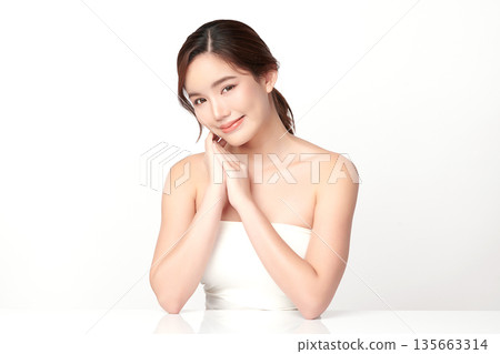 A beautiful young Asian woman with clean, fresh skin against a white background. Skincare, facial treatment, cosmetology, beauty, and spa. An elegant portrait of an Asian woman. A beautiful young Asian woman with clean, fresh skin against a white background. Skincare, facial treatment, cosmetology, beauty, and spa. An elegant portrait of an Asian woman. 135663314