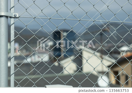 View of the cityscape from the diamond-shaped wire mesh View of the cityscape from the diamond-shaped wire mesh 135663753