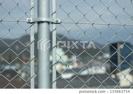 View of the cityscape from the diamond-shaped wire mesh View of the cityscape from the diamond-shaped wire mesh 135663754