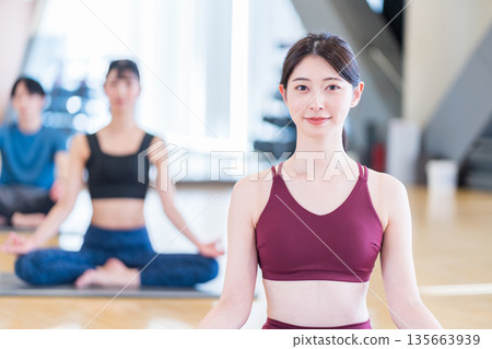 Young women practicing yoga. Photo courtesy of: Sports Club & Sauna Spa Renaissance Makuhari 24 Young women practicing yoga. Photo courtesy of: Sports Club & Sauna Spa Renaissance Makuhari 24 135663939