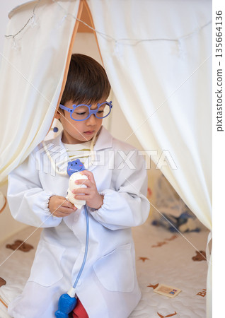 Young Boy Pretending To Be A Doctor In A Play Tent Environment 135664136