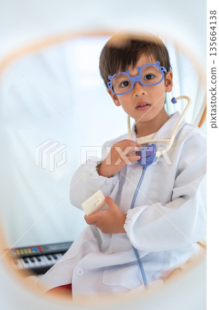 Little Doctor With Play Medical Equipment In A Cozy Tent Little Doctor With Play Medical Equipment In A Cozy Tent 135664138