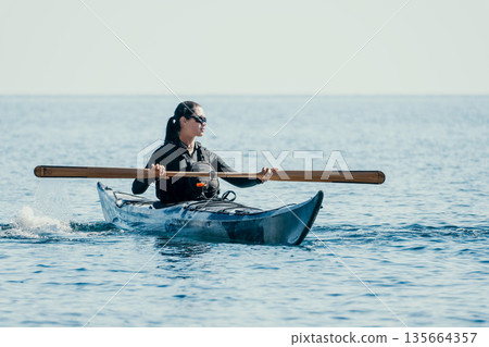 Kayaking Ocean Water Sport - Person paddling a kayak in the ocean on a sunny day. 135664357