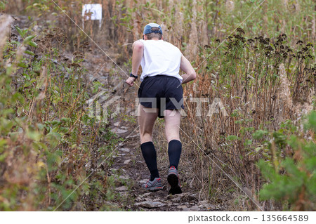 Rear view male athlete running Rear view male athlete running 135664589
