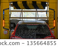 Automobile moving through a modern automatic car wash tunnel during cleaning process. 135664855